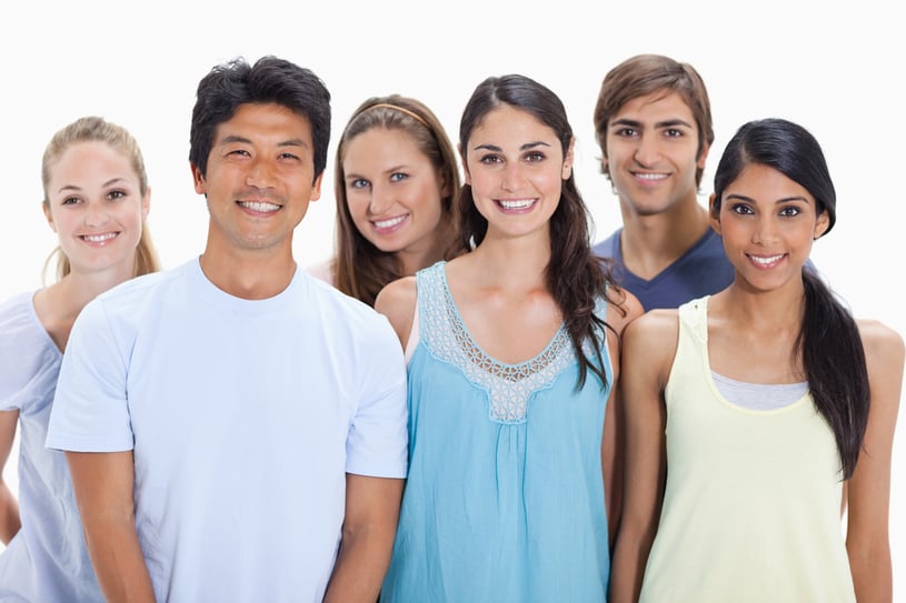 Close-up of people smiling together against white background