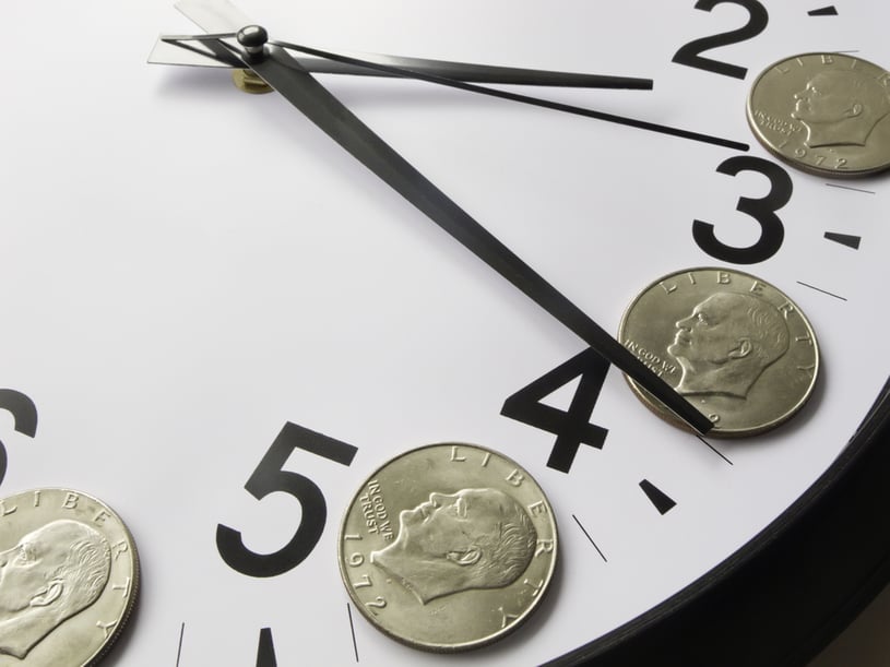 Concept of time is money Eisenhower dollar coins on face of analog clock